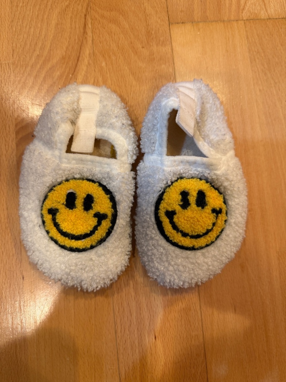 White Fuzzy Baby Slippers with Yellow Smiley Face